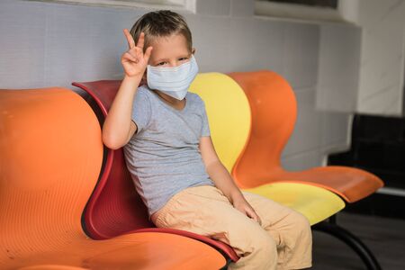 Boy wearing facial disposable mask to avoid viral infection. Virus protectionの写真素材