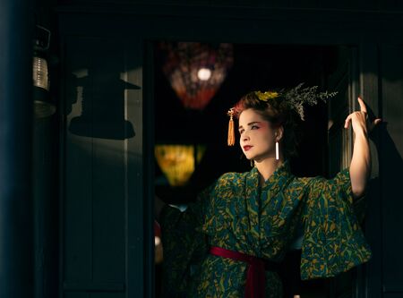 Fine art portrait of beautiful woman in Japanese Geisha style wearing kimonoの写真素材