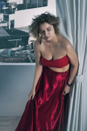 Fashion style portrait of a beautiful  woman on a balconyの写真素材