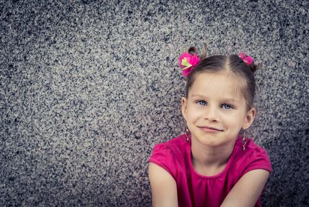 Outdoor portrait of a young girl in pink dressの写真素材