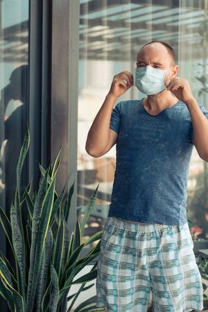 Man wearing facial disposable mask to avoid viral infection. Virus protectionの写真素材