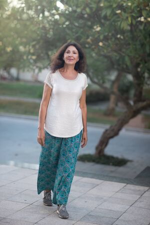 Outdoor portrait of a beautiful smiling senior womanの写真素材