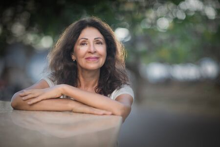 Outdoor portrait of a beautiful smiling senior womanの写真素材