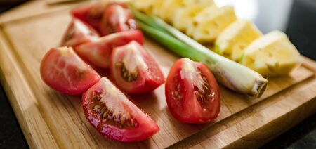 Ingredients set for sweet and sour sauce. Tomatoes, pineapple, lemongrass and gingerの写真素材
