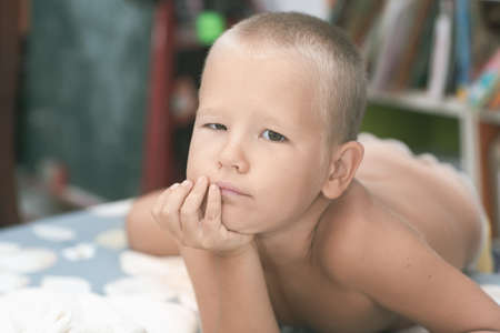 Indoor portrait of cute little serious boyの写真素材