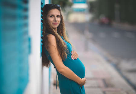 Outdoor portrait of a beautiful pregnant womanの写真素材