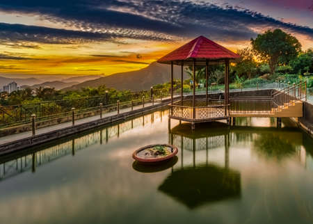 Pavilion on the pond at sunset. Mountain on background. Vietnamの写真素材