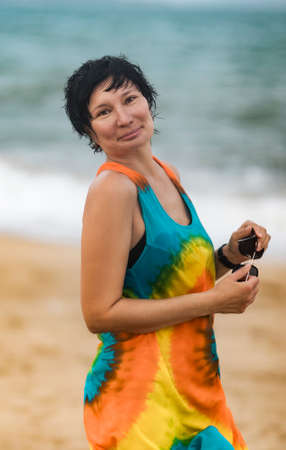 Outdoor portrait of a beautiful smiling woman near the seaの写真素材