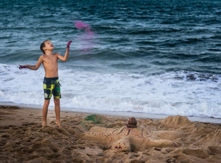 Outdoor portrait of a little cute boy playing colorsの写真素材