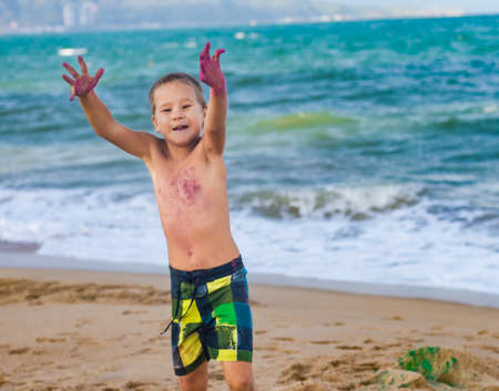 Outdoor portrait of a little cute boy playing colorsの写真素材