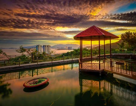 Pavilion on the pond at sunset. nha Trang city on background. Vietnamの写真素材