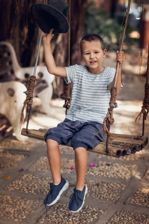 Boy having fun time on the swingの写真素材
