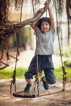 Boy having fun time on the swingの写真素材