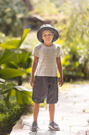 Outdoor portrait of a cute boy in hatの写真素材