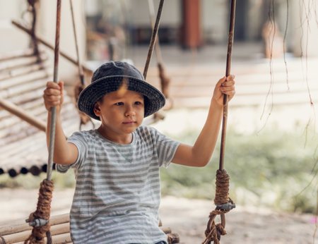 Boy having fun time on the swingの写真素材