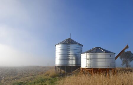 Storage silos in outback field, Queensland Australiaの写真素材
