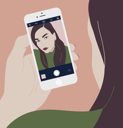 Young brunette woman holding smartphone and making selfie photo on front-facing camera. Long haired...