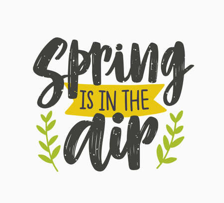 Spring Is In The Air inspiring phrase written with artistic cursive font or script and decorated with green leaves or branches. Seasonal lettering isolated on white background. Vector illustration.のイラスト素材