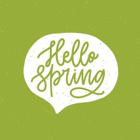 Hello Spring phrase handwritten with elegant cursive font or script inside speech balloon or bubble on green background. Springtime seasonal lettering or inscription. Hand drawn vector illustration.のイラスト素材