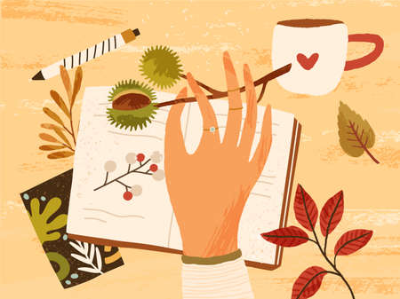 Cozy autumn composition with hand holding branch with chestnut, fall leaves, berries, notebook, pen and a cup of hot beverage. Autumnal hygge atmosphere. Flat textured vector illustrationのイラスト素材