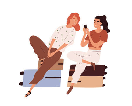 Couple of tourists with luggage waiting for flight. Passengers sitting on suitcases and looking photos in mobile phone. Colored flat cartoon vector illustration of women isolated on white backgroundのイラスト素材