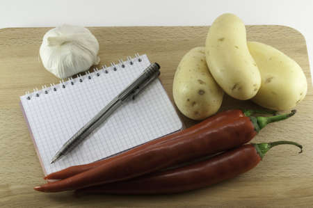 Still life of the notebook with a pen, and products