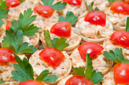 Little snack in the basket with cherry tomatoesの写真素材