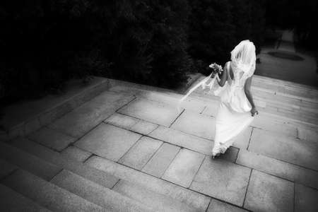 A bride walking away down a staircaseの写真素材