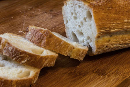 sliced baguette bread on the board close upの写真素材