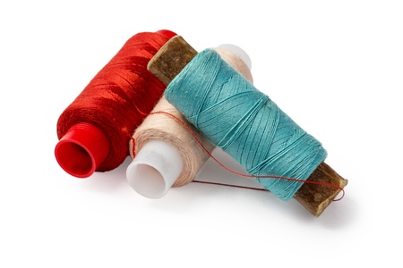 different colours thread spools isolated on white background