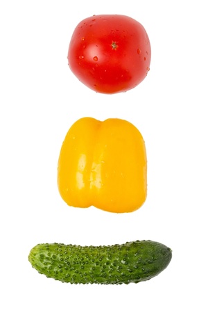 cucumber bell pepper and tomato in traffic light order isolatedの写真素材