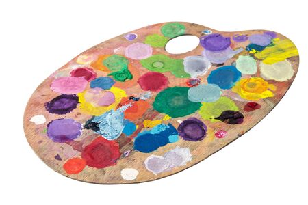 wooden palette with spots of paint gouache isolated on whiteの写真素材