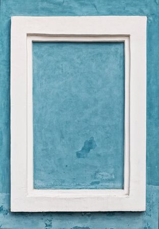 white frame on blue wall with stains and spotsの写真素材