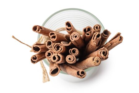 tied sticks of cinnamon in the glass isolated on whiteの写真素材