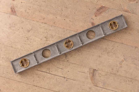 old builder's level laying on wood floor