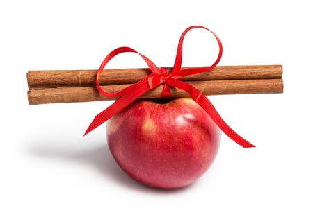 apple and cinnamon sticks isolated on whiteの写真素材