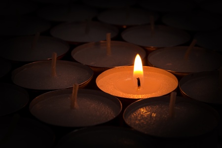compositiopn from one burning candle lights othersの写真素材