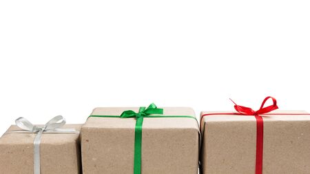 three gift boxes in a row isolated on whiteの写真素材
