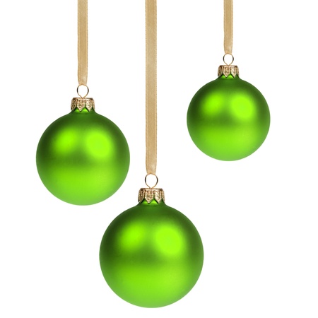 three christmas balls hanging on ribbon isolated on whiteの写真素材