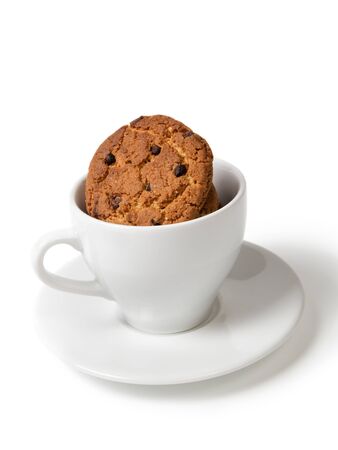 cookies with chocolate pieces in cup isolatedの写真素材