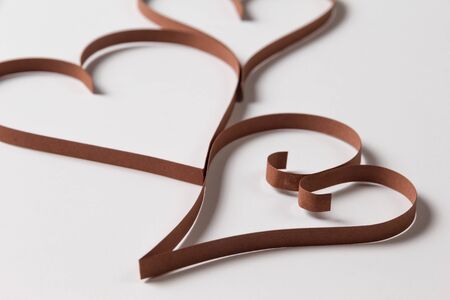 three paper hearts on white paper, valentines day backgroundの写真素材