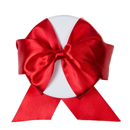 round gift box wrapped with ribbon, isolated on white backgroundの写真素材