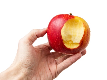 bitten apple in hand, isolated on white backgroundの写真素材