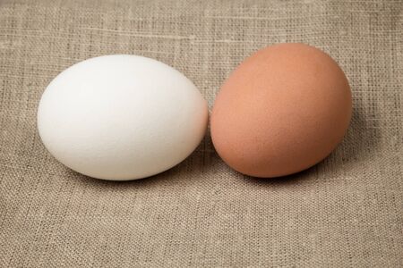 two eggs on burlap, rustic easter backgroundの写真素材