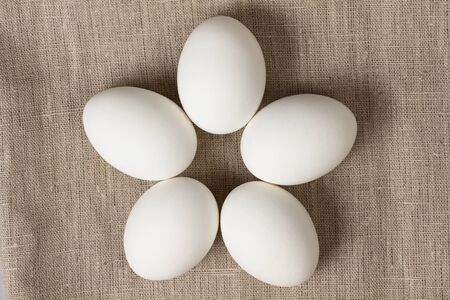 chicken eggs on burlap, rustic easter background