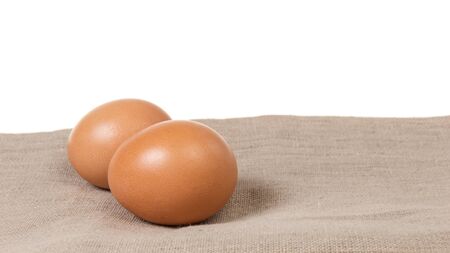 two eggs on burlap, rustic easter backgroundの写真素材