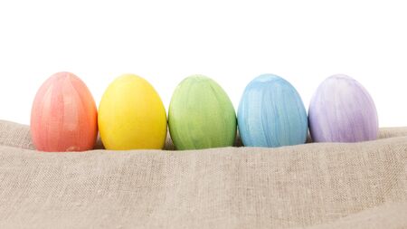 easter eggs on burlap in a row, rustic easter backgroundの写真素材