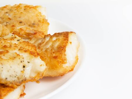 fried in flour codfish on plate, border composition