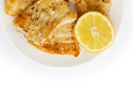 fried in flour codfish on plate, isolated on white background