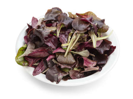 purple spinach leaves in bowl, isolated on whiteの写真素材